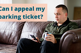 An adult man sits on a sofa at home. He is holding a mug in one hand and scrolling through his phone with the other. Text above him reads ‘Can I appeal my parking ticket?’