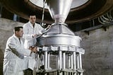 Technicians in a vacuum furnace at Lewis’ Fabrication Shop prepare a Kiwi B-1 nozzle for testing in the B-1 test stand (5/8/1964).