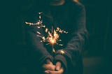 Sparkler — tiny fireworks held by a man