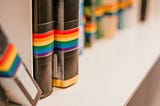 Shelf with LGBTQ awareness books at the public library. Photo by Christina Vartanova from Shutterstock.