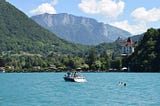 A water-skier waits behind an idling boat in Lake Annecy.