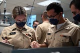 Students at Naval Nuclear Power Training Command (NNPTC), solve equations in a fluid theory lab.