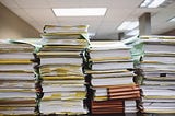 Several tall stacks of paper in folders