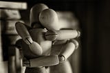 Two wooden dummy figures hugging