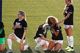 Julie Ertz and Casey Short embrace during the NWSL Anthem Ceremony