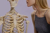 girl looking closely at skeleton