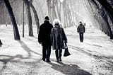 elederly couple walking together in a park