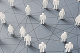 A network of interconnected figures, each representing a person. The figures are white and placed on a grey background with lines connecting them.
