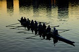 A team of rowers rowing a canoe
