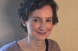 A photo of interviewee Jenni Elbourne — a smiling lady with short wavy brown hair