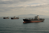 ChatGPT generated landscape image of empty container ships anchored offshore near Long Beach, symbolizing disrupted trade flows and idle port activity