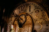 Close-up of an ornate vintage clock face in warm, low light, symbolizing time pressure and urgency. Photo by Nguyen Mazic on Unsplash