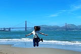 Anupriya against the backdrop of Golden Gate bridge and beach in San Francisco