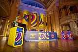 stage in concert room at st george’s hall, dressed with eurovision tables and branding