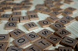 Scrabble tiles laid out randomly on a flat surface