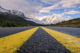 Diminishing perspective of yellow painted highway lines.