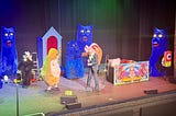 Harry Hill on stage at Newcastle’s Tyne Theatre, with an audience member dressed as a hamster, as other cast members dressed as Stouffer the Cat, a badger, and an ice cream, with a small convoy of badgers in remote controlled cars traversing the stage in the backgorund. You sort of had to be there, really …