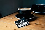 Coffee Cup and Name Tag on Table