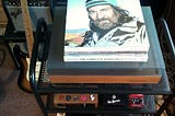 Stack of vinyl long playing records with Willie Nelson’s ‘A Whiter Shade Of Pale’ lying on top of a Hi-Fi System record deck in a music room