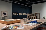 An inside view of an art gallery with a conservation table in the forefront.