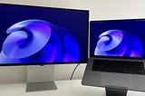 The Samsung monitor on the left, with a 16″ M1 MacBook Pro connected to its right.