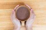 Hands holding cup of hot chocolate on wooden table. Photo 194629794 | Cafe © Natthawut Thongchomphoonuch | Dreamstime.com