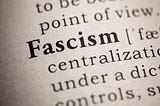 Close up view of a dictionary definition of fascism with the word Fascism capitalized