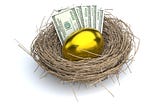 A golden egg with some cash next to it