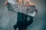 Man reading a burning newspaper