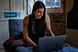 Community entrepreneur on bed with laptop