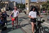 Picture of Scott Wiener in drag with a red bike