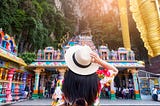 A woman sightseeing at Batu Caves in Kuala Lumpur, the main site for celebrating the annual Hindu festival of Thaipusam.
