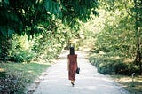 Woman walking on beautiful green path