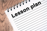 a spiral note pad used for writing a lesson plan