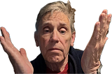 A person with short gray hair is raising both hands in a confused or uncertain gesture.