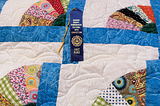 quilt with first place ribbon from the Jackson County Homemakers Cultural Arts Competition