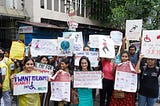 People holding placards at a disability rights protest.