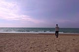 Lloyd on a sandy beach looking out to sea