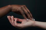 One black and one white hand on top of each other