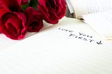 Living Your Abundant Life Promo — Photo of roses and notebook that reads love you first