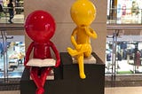 Two dummies representing reading and thinking.