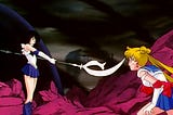 A photo of Sailor Saturn pointing her weapon, the Silence Glaive at Sailor Moon before she goes to destroy Pharaoh 90 in Sailor Moon S