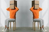 On the left, aperson in an orange sweater with a cardbox on their head that says “brain.” A mirror image of the stock photo appears on the right.