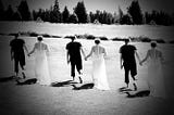 Author with ex-wife on his wedding day walking into meadow.