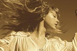 Album cover: Fearless (Taylor’s Version)- 2021 release. A photograph of Taylor Swift, with her hair moving in the wind.