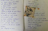 Two pages covered in angular handwriting with a little glued illustration of a woman holding wild flowers.
