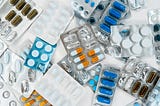 A colorful array of antibiotic tablets in partially used packets.