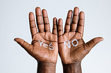 Two brown-skinned hands side by, palms open. One has “yes” written on it. One has “no” written on it.