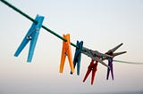 A clothesline with colorful pegs.