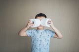 Boy, looking through toilet paper rolls as thought they are binoculars